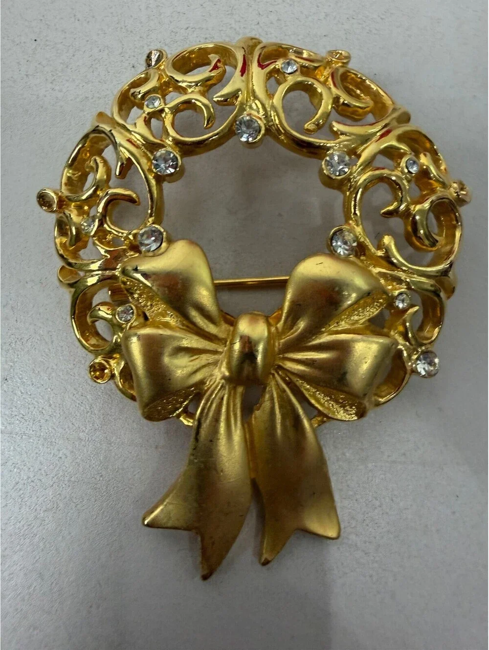 Vintage JJ Gold Tone Wreath Brooch with Bow and Rhinestones